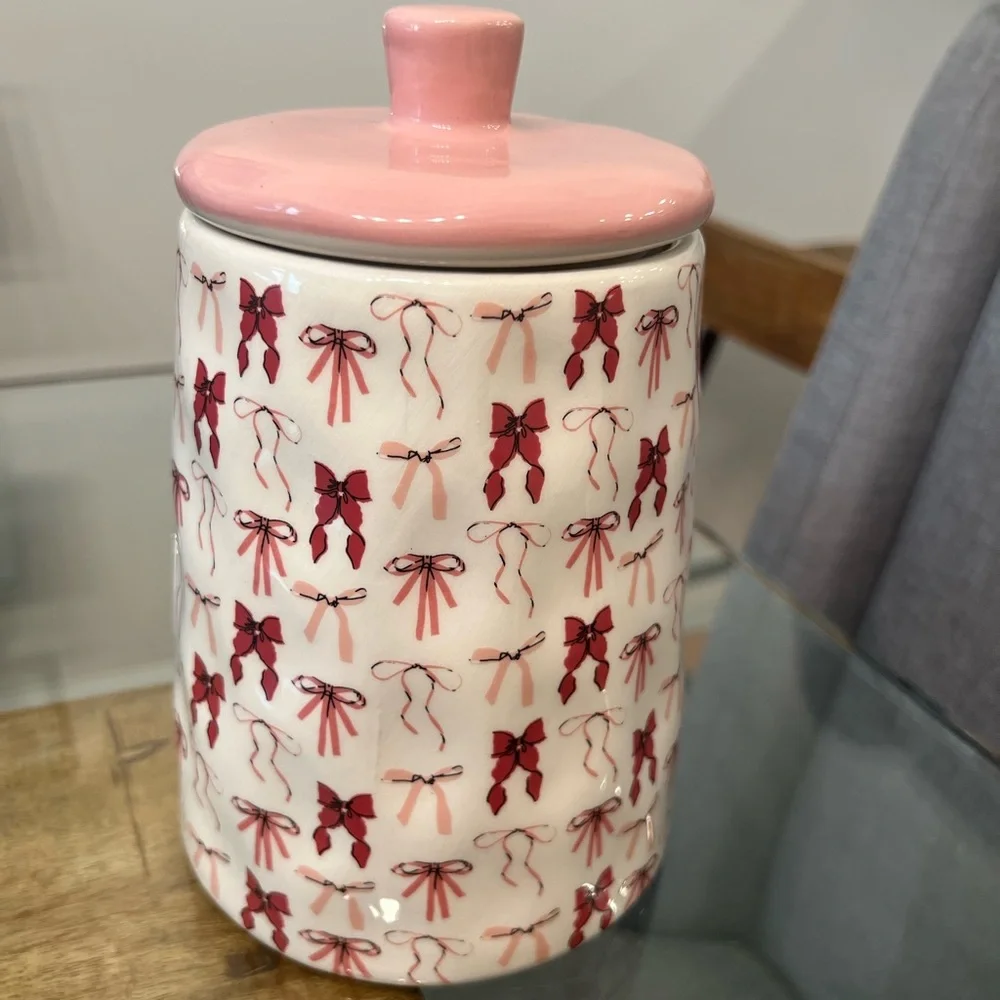 canister jar with a pink bow design, from the brand 10 Strawberry Stree